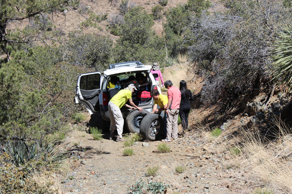 Eric changes his tire on the drive towards the trailhead