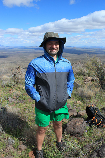 Adam braving the cold wind and sharp brush in shorts