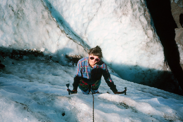 Linda "front pointing" up the wall of a crevasse. She uses two ice tools and the front points of her crampons to climb the ice.
