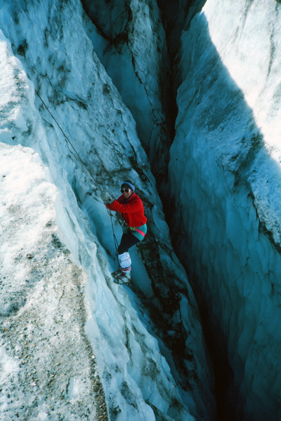 Linda "prussiks" out of a crevasse. Here she uses a pair of cord loops (prussiks) knotted around the climbing rope to ascend the rope to and over the lip of the crevasse. Perhaps I should have had her on belay in case the cords failed.