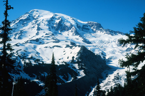 Mount Rainier from near Paradise Lodge. In this view our route crossed the Nisqually Glacier on the lower right from right to left and up onto the obvious ridge just right of center for our first camp. The next day we climbed the broad snowy ridge towards the upper left to just below the ice cliffs for our second camp. The third day we climbed around the ice cliffs up the Kautz Glacier to the summit (14411'), returned and broke camp, and descended back to Paradise Lodge (5420') and our cars.