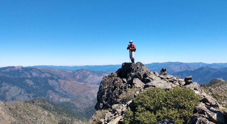 I stand on the summit of Big Craggies, surrounded by the Siskiyou Mountains (Caleb Morris photo)