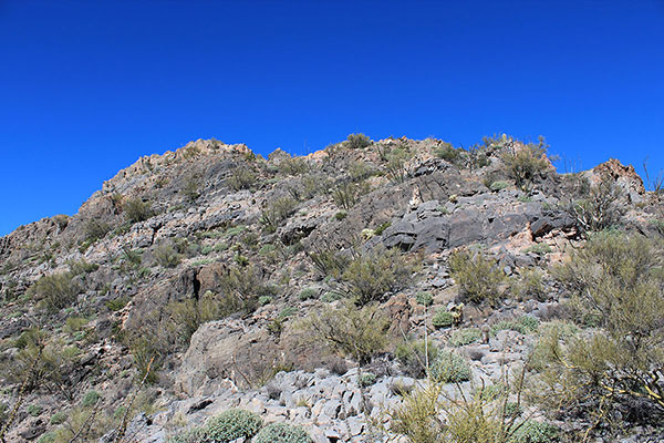 The false summit rises above us on the ridge above the south face