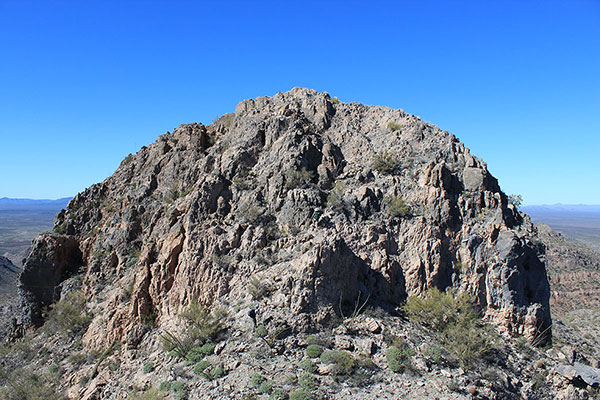 Matthias and Scott P. scramble up the rocky summit block