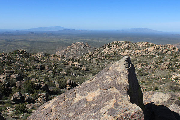 The view southwest from the summit boulder. Harquahala Mountain is in the distant left and Smith Peak is on the right.