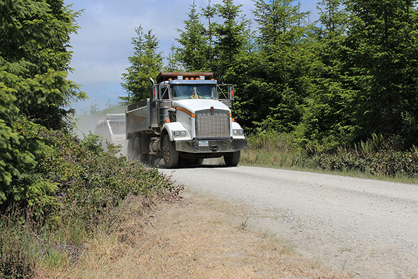 Gravel dump trucks and trailers repeatedly passed us as they carried gravel down to the road work site.