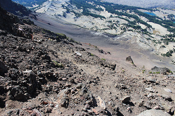 Slings are on the left just above a sandy and loose slope and our ascent routes up the basalt wall