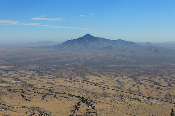 The USA/Mexico border wall and Sierra San José, Sonora Mexico, from Montezuma Peak