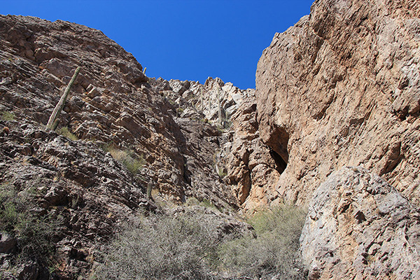 The trail traverses below the steep south face of the cliffs