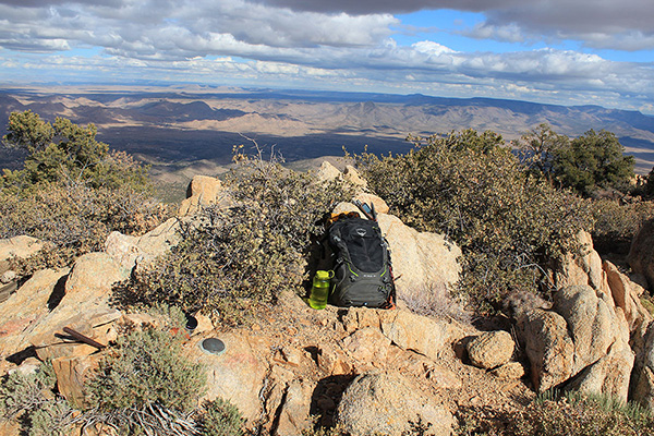 The Peacock Peak summit with registry bottle and benchmark below to the left