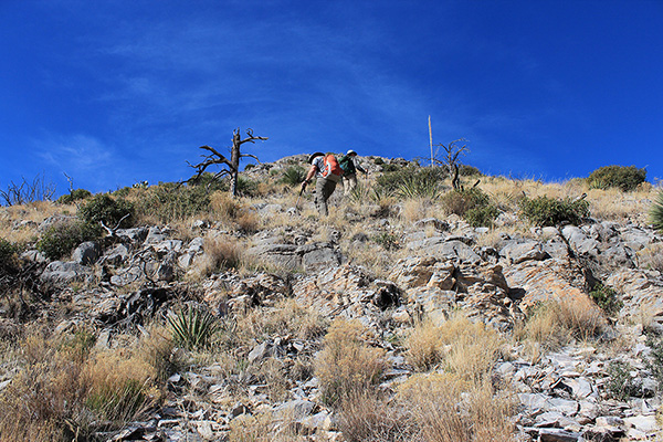 Scott and Matthias climbing up a steep slope to the ESE Ridge