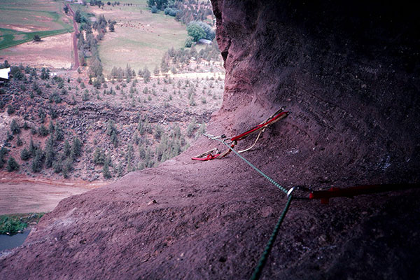 I belay Linda as she climbs the bolt ladder towards Monkey Face's mouth cave.