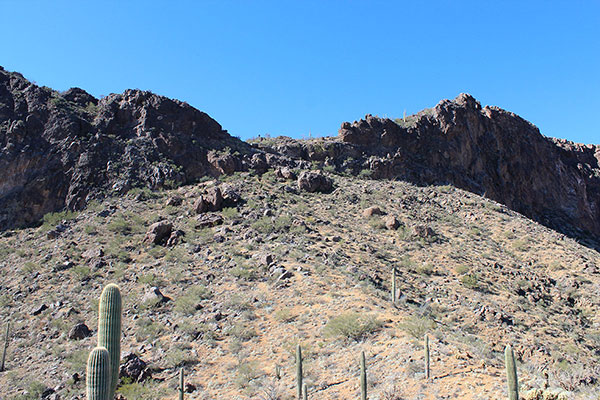 An open slope leads up towards the notch.