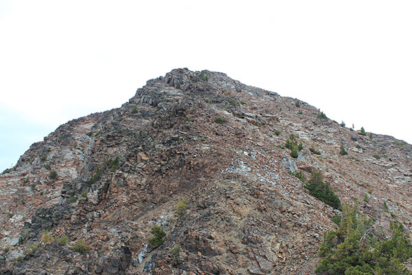 The South Face is a mixture of rock bands and loose talus. The summit is high on the left.