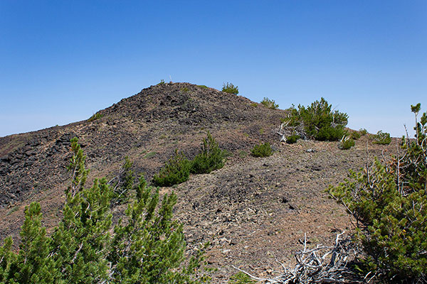 Approaching the summit, marked by a post