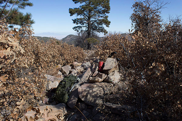 Pastora Peak summit cairn and registry; Ute Peak in Colorado rises in the distance