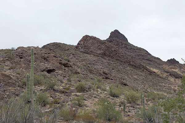 I approach the Southeast Ridge. My route leads left below the high cliff into a gully then up to a saddle higher