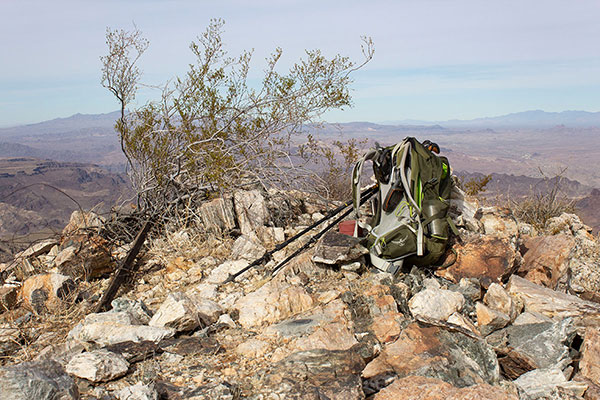 The Planet Peak summit. The PLANET benchmark lies to the left of my pack. The red can contains a jar with the summit registry.