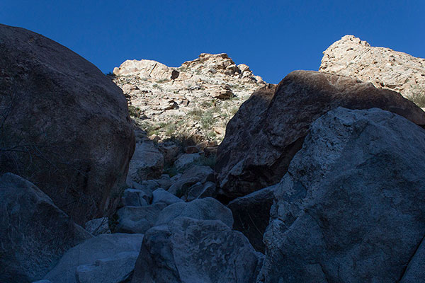 We start climbing around and over boulders as soon as we enter the canyon