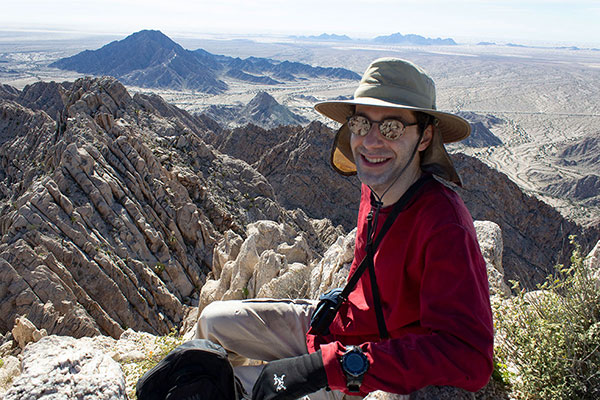 Michael relaxing on the highpoint of the Tinajas Altas Mountains