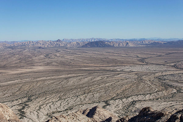 To the east lies dark Tordillo Mountain, the Cabeza Prieta Mountains, and the Sierra Pinta beyond