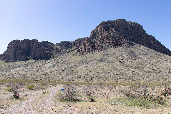 Our route enters the broad NE gully to the left, then turns to the right behind the cliffs.